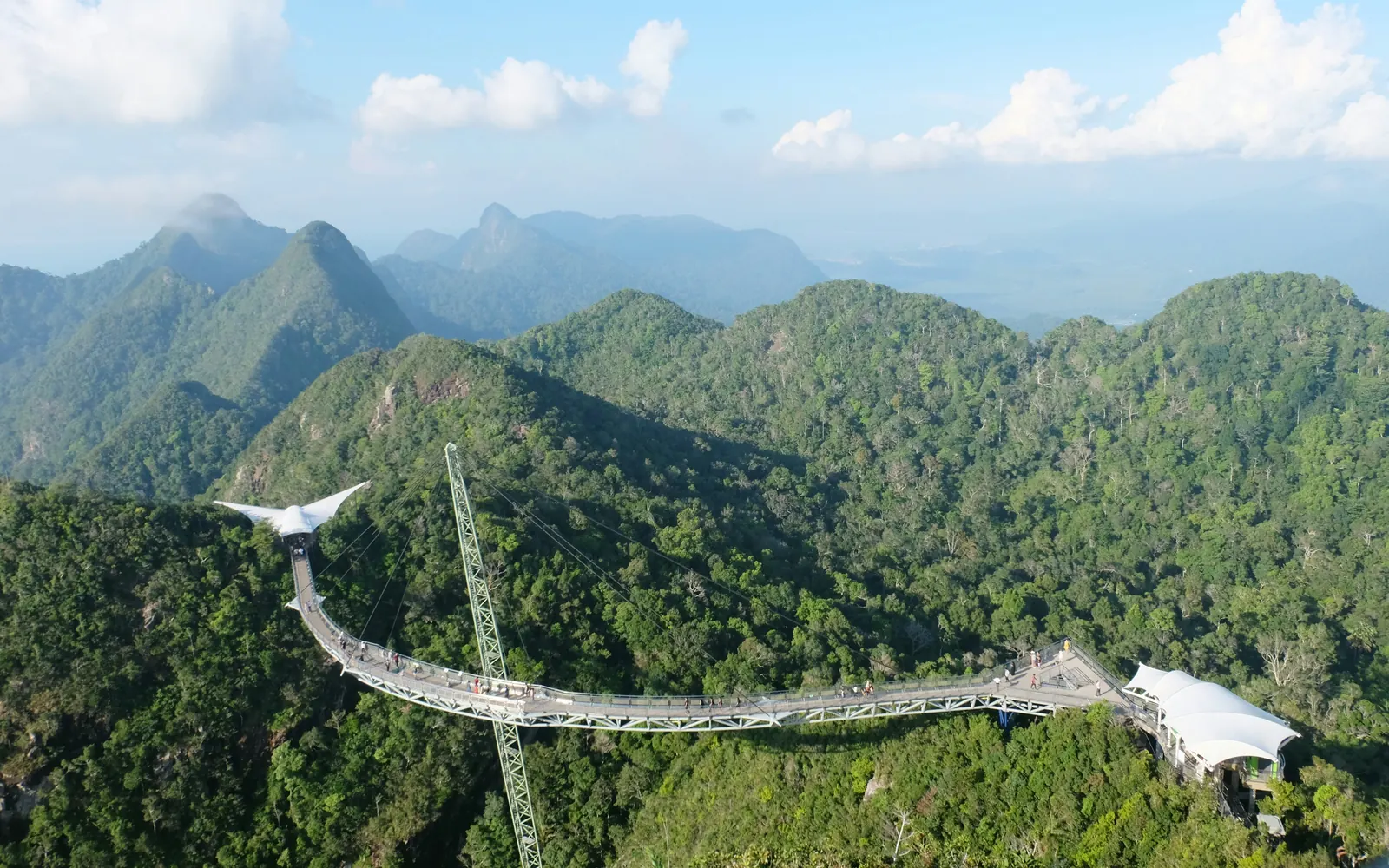 The curved Langkawi Sky Bridge above forested mountain peaks