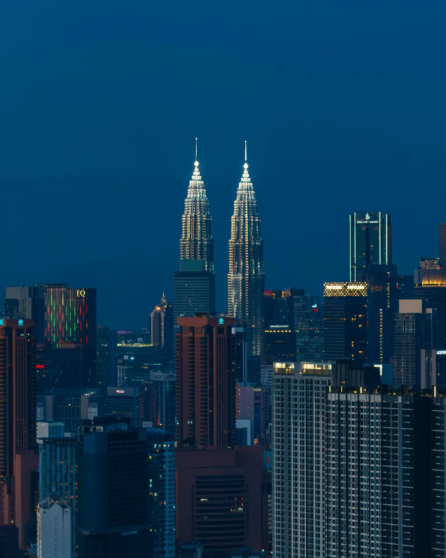 The Petronas Twin Towers rising above Kuala Lumpur at blue hour